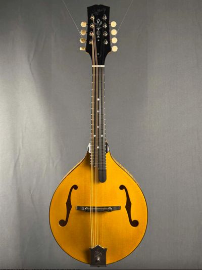 A classic wooden mandolin with a teardrop body and ornate tuning pegs.