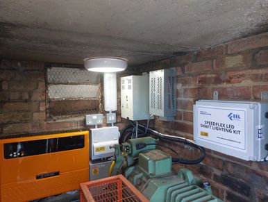 Industrial equipment and control panels installed in a brick-walled utility room.