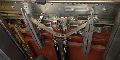 Close-up of mechanical parts inside an elevator shaft.