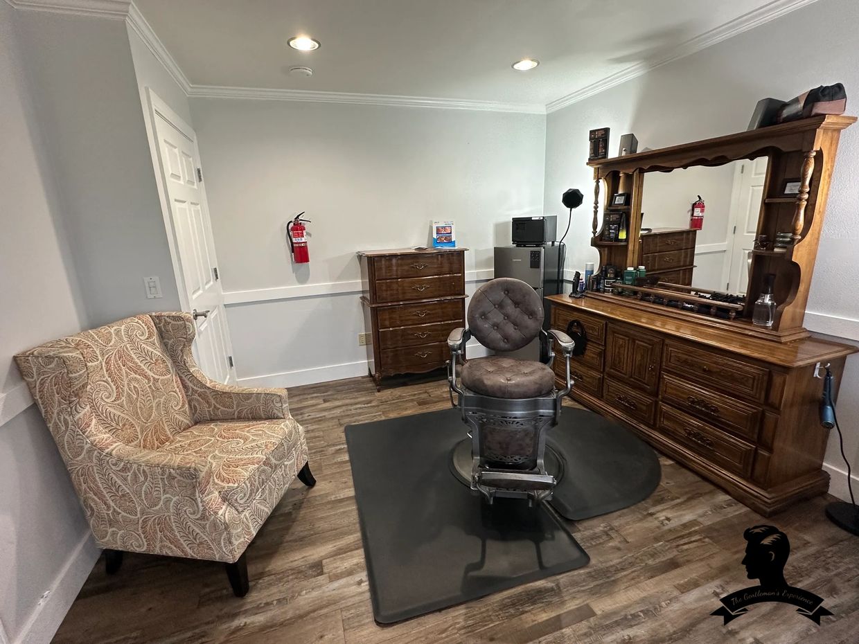 Vintage barber chair in a cozy, neatly organized grooming room with wooden furniture.