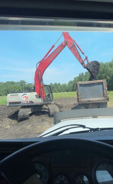 Excavator loading dirt into a dump truck.