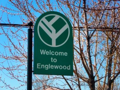 A green 'Welcome to Englewood' sign.