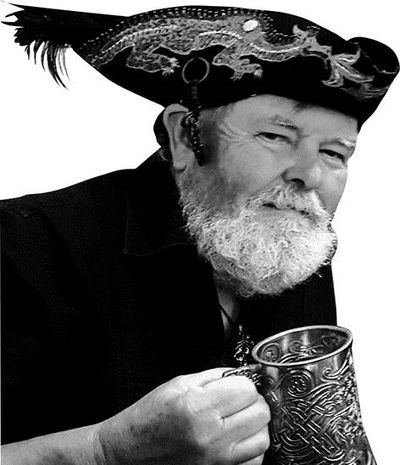 Picture of an old man dressed as a pirate holding a mug