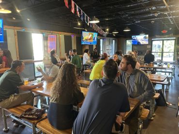 People socializing at a lively indoor restaurant.