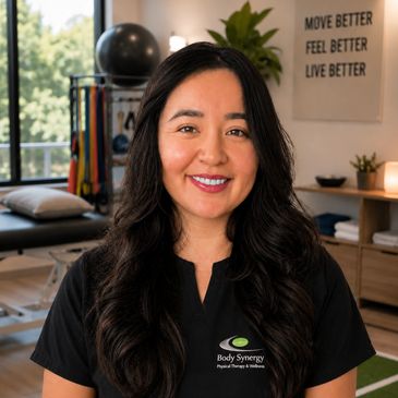 A smiling physical therapist in a wellness clinic.