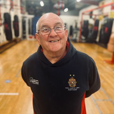 Dennis Stinchcombe smiling in the gym.