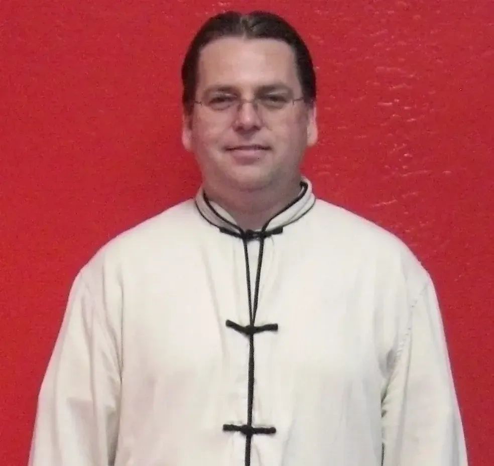 Man wearing white dress with looking ahead