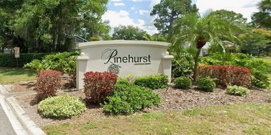 Entrance sign for Pinehurst community with landscaping.