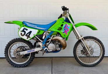 Bright green Kawasaki dirt bike with number 54.