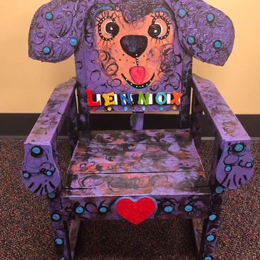 Colorful child chair with dog face design and name.