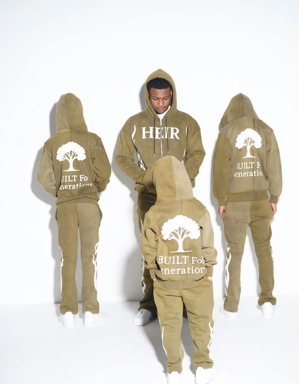 Four people wearing matching olive green hoodies and pants with white text and tree graphics.