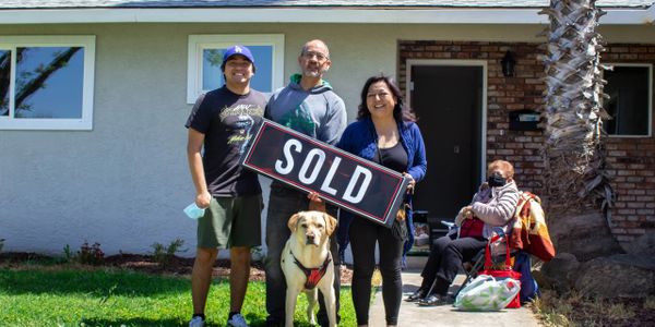 Happy family and their dog celebrates their investment home purchase. 