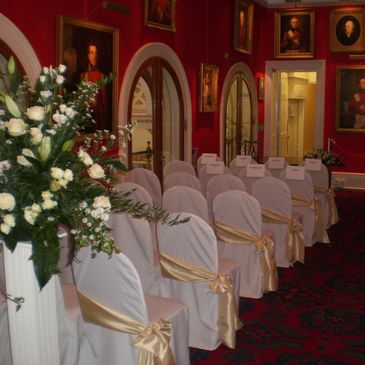 Chair covers and Gold sashes for a wedding ceremony