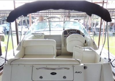2004 Sea Ray 240 Sundancer with Bimini and Camper frames, both in storage boots.