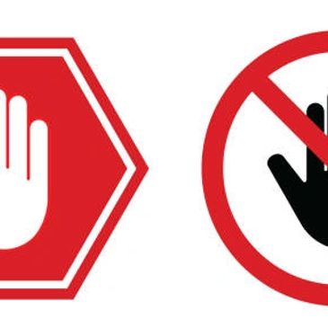 Two stop signs each with a hand symbol, one white on red octagon, one black on white circle with red slash.