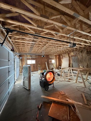 Construction heater warming an unfinished garage under renovation.