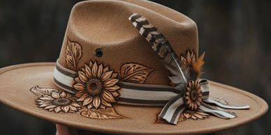 A stylish brown hat adorned with flowers and a feather.