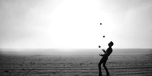 Man juggling in a field