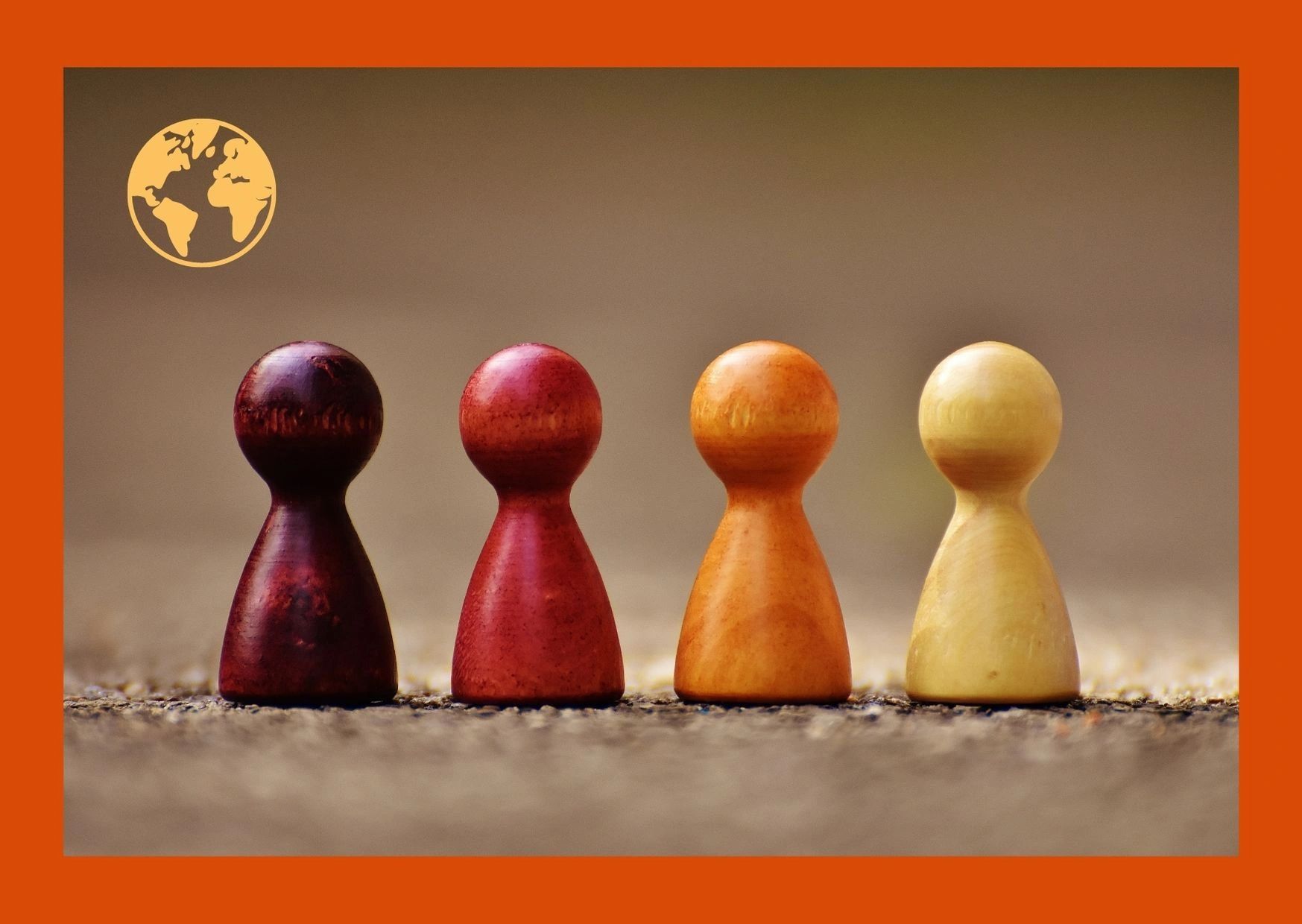 Four wooden pawns in different shades, symbolizing diversity and unity.