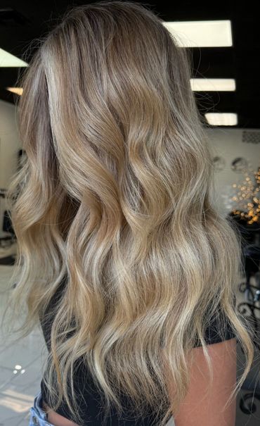 Long, wavy blonde hair with subtle highlights.
