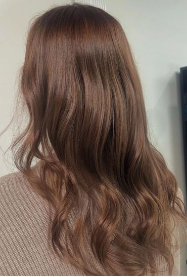 Long, wavy brown hair with a smooth and shiny texture.