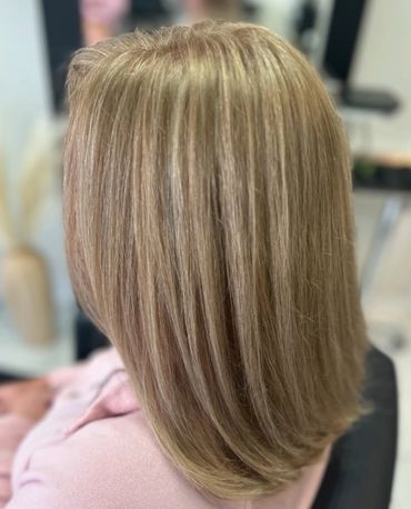 Smooth, layered blonde hair styled straight and sleek.