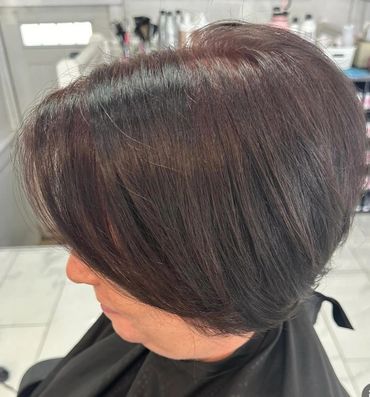 Short layered bob haircut with subtle highlights.