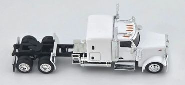 White semi-truck tractor without a trailer on a gray background.