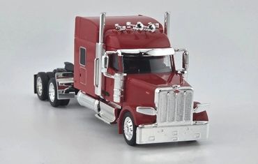 Red toy semi truck with chrome details on white background.