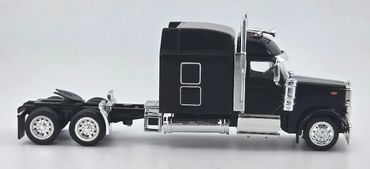 Side view of a sleek black semi-truck model with chrome details.