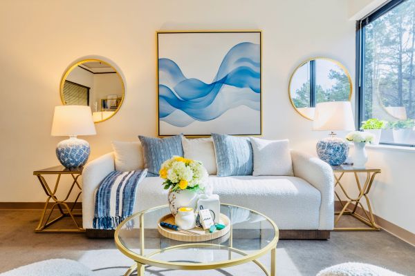 Bright living room with blue accents and gold details.