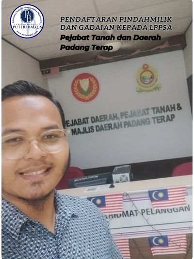 Man smiling inside Pejabat Tanah dan Daerah Padang Terap office with flags.