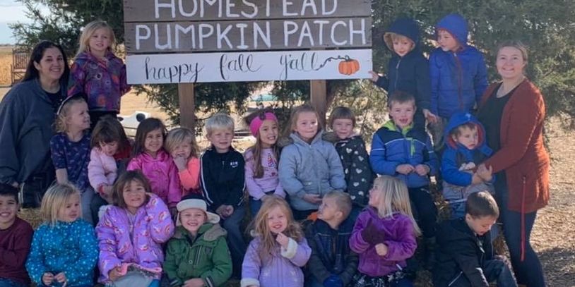 Group of children and two adults at Homestead Pumpkin Patch.