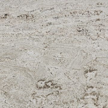 This granite has a white background tone with small quartz crystals and flecks of mica.