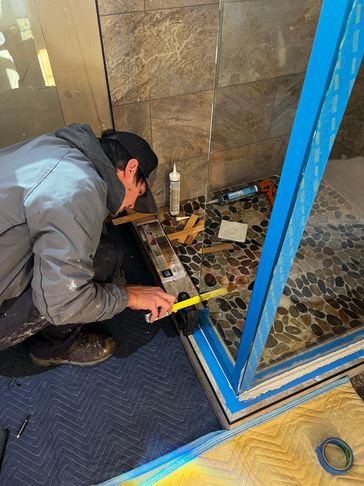 Owner of Precision Glass, Brett, getting the details precisely right on a custom glass shower