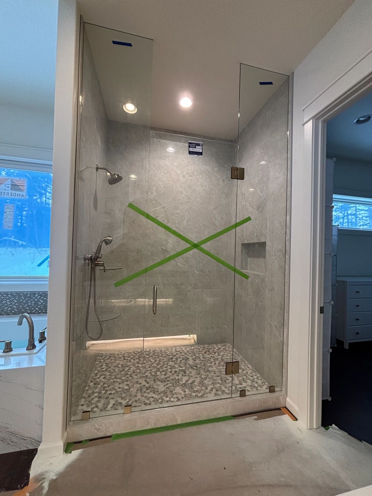 Custom shower with large custom glass side panels and a standard custom shower glass door