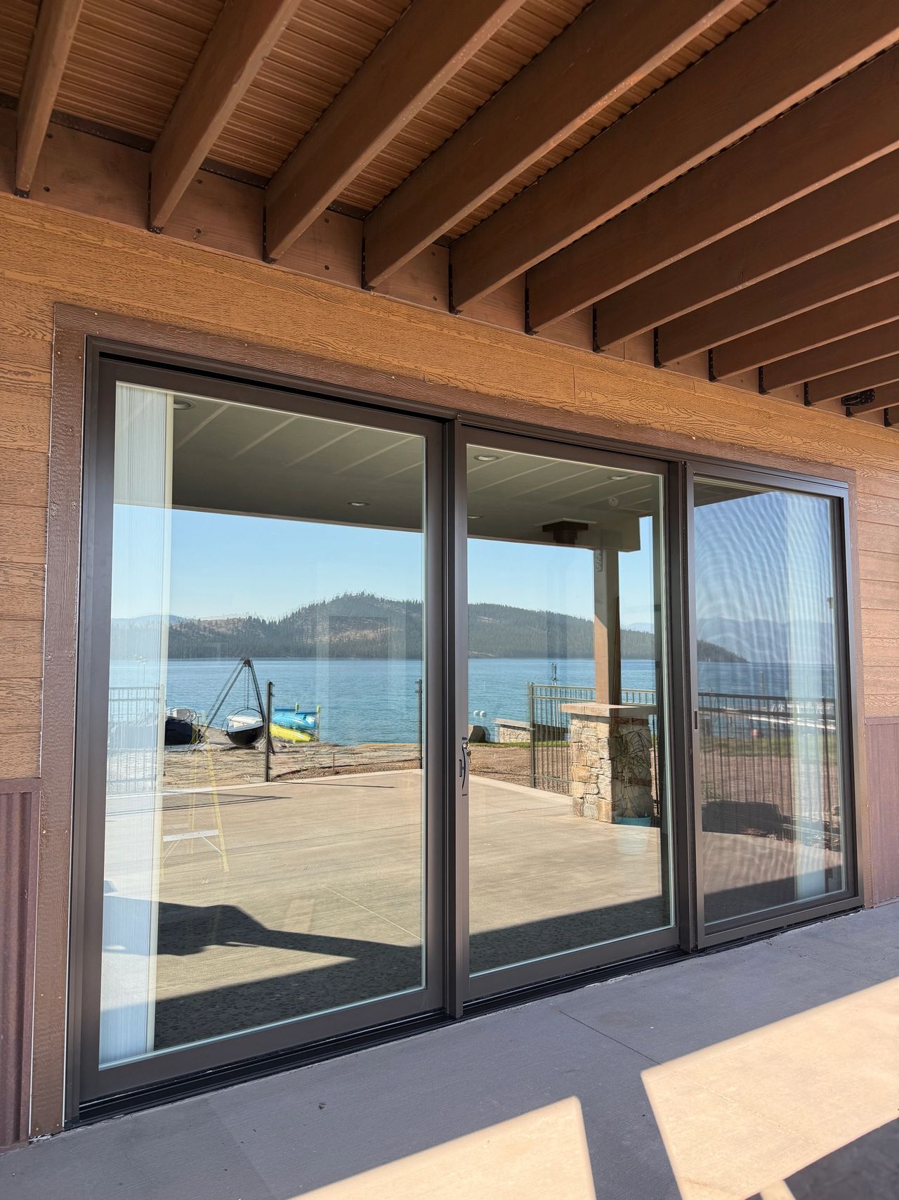 The exterior view of lower the Pella Lifestyle triple sliding door Precision Glass installed in Lakeside Montana