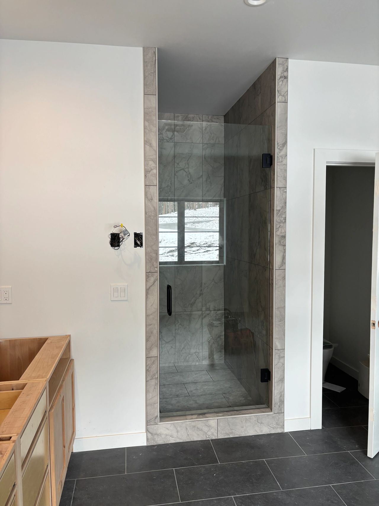 Custom hinged glass shower door that Precision Glass installed for a Whitefish MT client