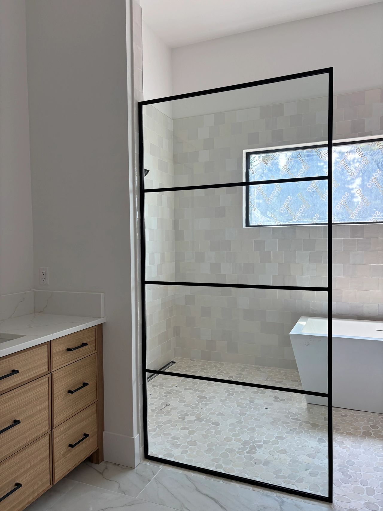 The second custom shower panel installed in Whitefish 59937 for a Precision Glass client with clean modern black lines & metal work