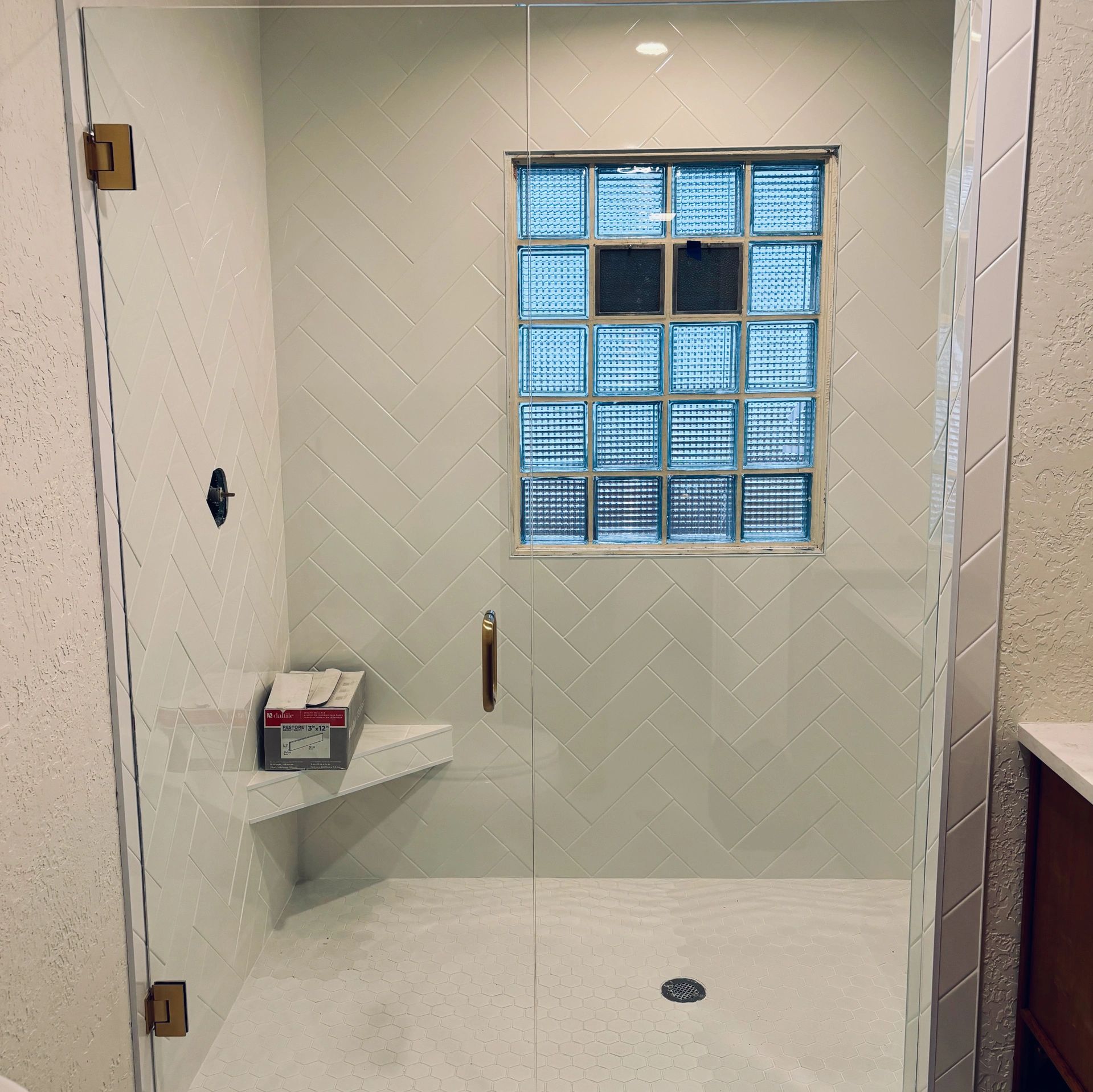 A tempered glass shower door and panel installed by Precision Glass in Columbia Falls Montana