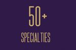 Graphic displaying '50+ Specialties' in elegant gold text on a dark purple background.