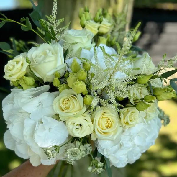 Elegant bouquet of white hydrangea, cream roses and lisianthus, hand-tied for luxury flower delivery