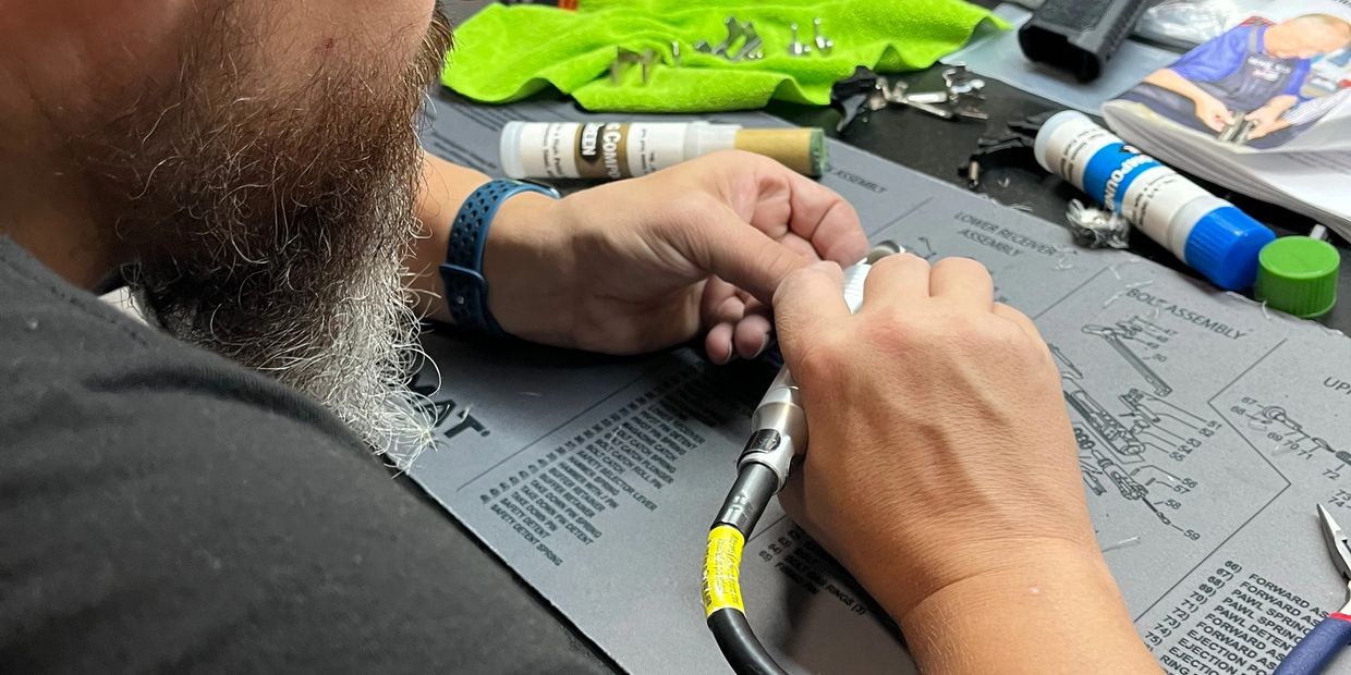 Patrick our certified Gunsmith polishing his Glock trigger system. 