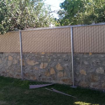 Chain link fence in rock wall
