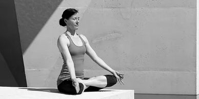 woman sitting in lotus pose meditating