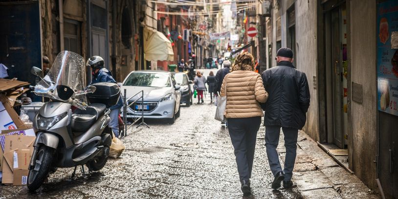 Travelers strolling down a vibrant European street - urban tours and personalized trip planning