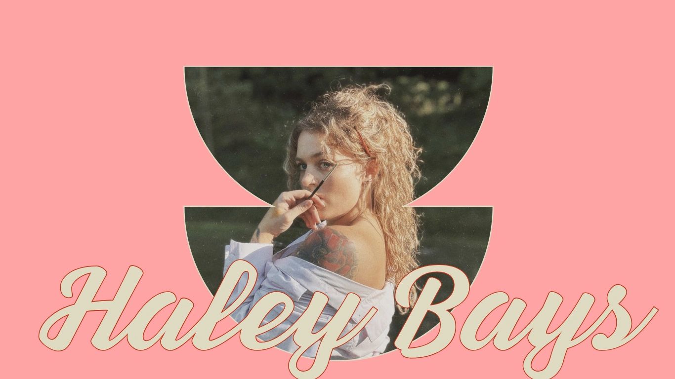 Artistic portrait of a woman with curly hair and tattoo, framed by pink and text.