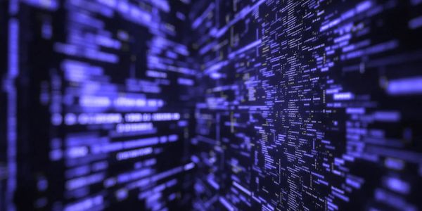 Blurred blue digital code streams on a dark background, symbolizing data flow.
