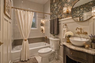 Elegant bathroom with vintage-style fixtures and floral wallpaper.