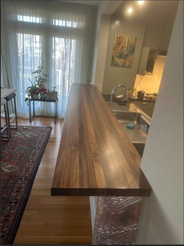 Finished 10 ft edge grain walnut bar. Constructed from customers tree slabs from tree in yard. 